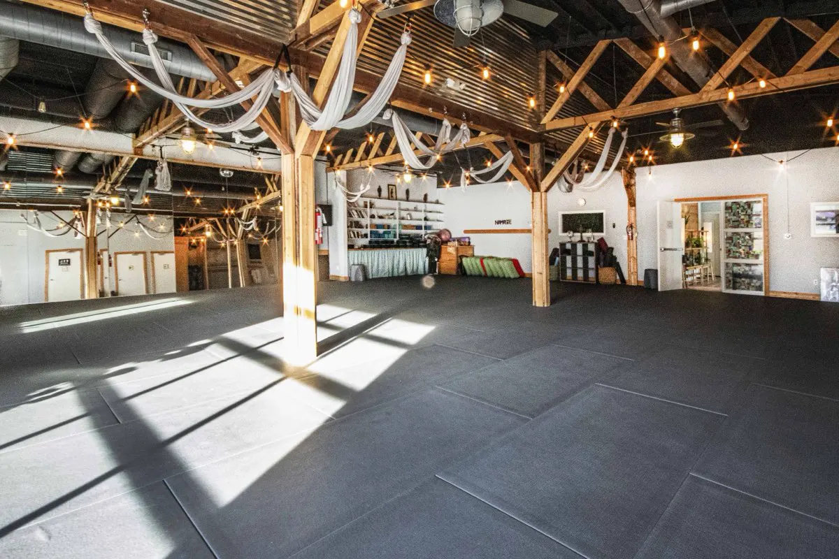 Renegade Yoga's studio room with wood beams and morning light