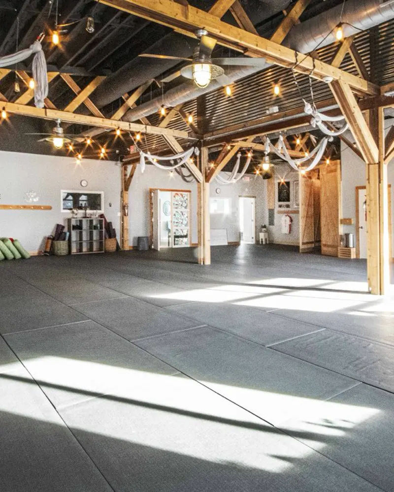 Renegade Yoga's main room in the afternoon, empty, with sun across the floor